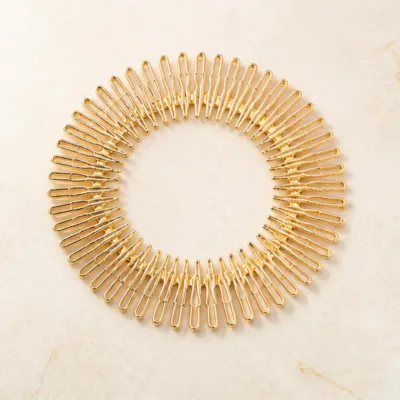 Travessa circular flexível dourada para cabelo