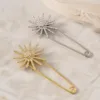 Alfinetes estrela radiante com cristais em prateado e dourado