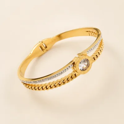 Bracelete dourado com corrente e cristal redondo central