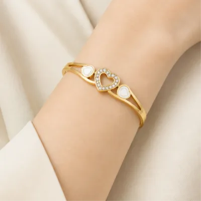 Gold-tone three-heart bangle 84812 worn on wrist