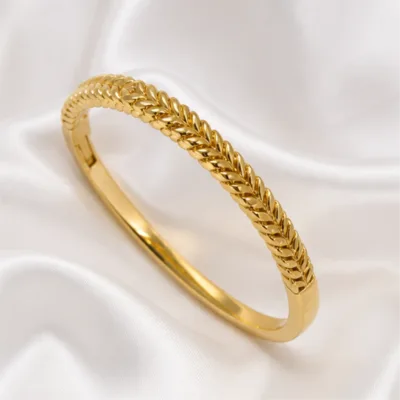 Gold-tone braided bangle 84826 on white satin
