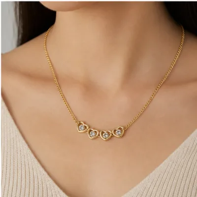 Gold-tone four-heart necklace 84838-02 worn at neckline