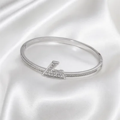 Silver-tone crystal bangle 84854-04 on white satin