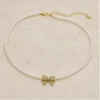 Colar de Pérolas com Laço Brilhante — Dourado