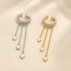 Ear cuffs com cristais e correntes de estrelas em prateado e dourado