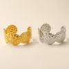 Pulseiras largas dourada e prateada com folhas marteladas
