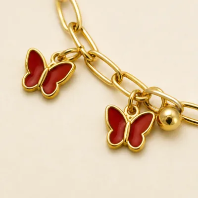 Close view of red butterfly charms on bracelet 85201-02-3