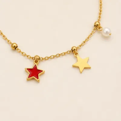 Close view of red and gold star charms on bracelet 85201-03-3