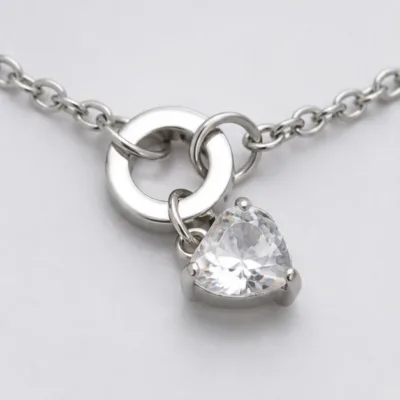 Close view of interlocking rings and heart stone on bracelet 85390-2