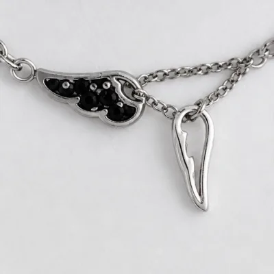 Close view of black-accent and polished wing charms 85390-3