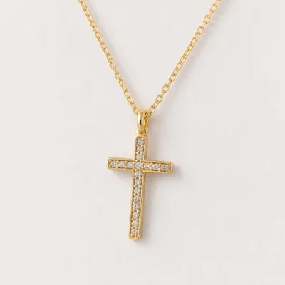 Close view of the gold-tone crystal cross pendant on necklace 85587